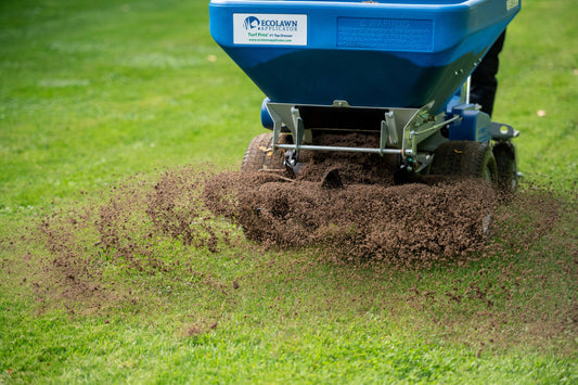 EcoLawn topdresser leveling a bumpy lawn with a quarter inch of screened compost