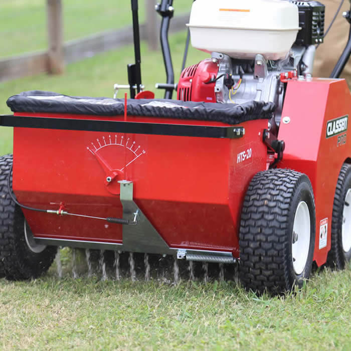 Slit seeder dropping grass seed into an existing Sheboygan County lawn