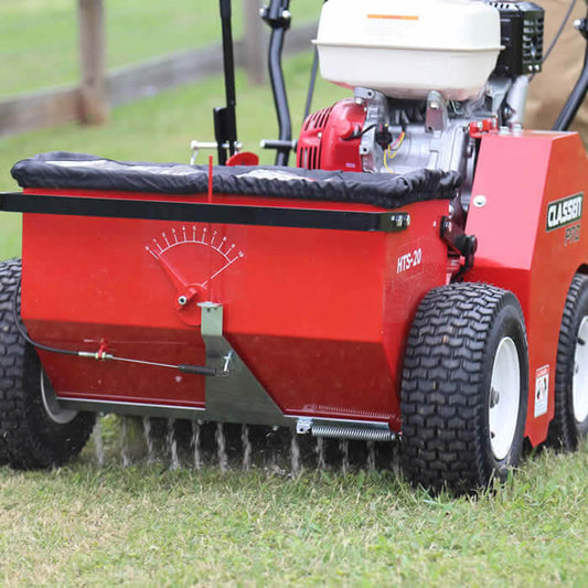 Slit seeder dropping grass seed into an existing Sheboygan County lawn