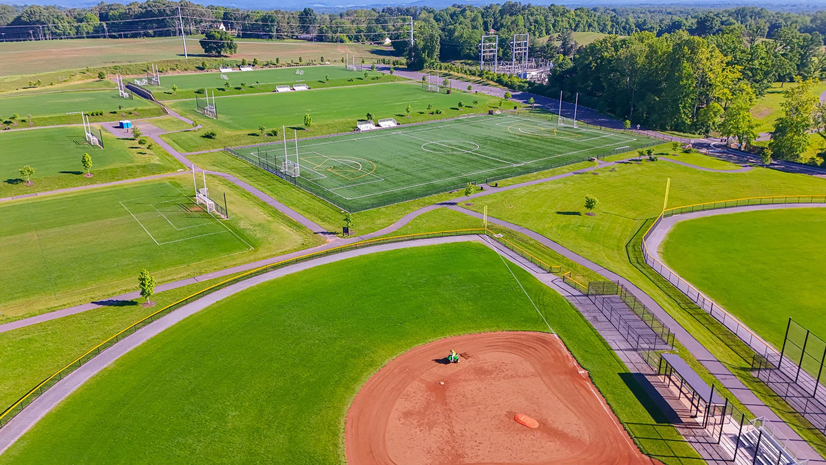 Aerial view of a municipal athletic complex with a baseball diamond and soccer fields