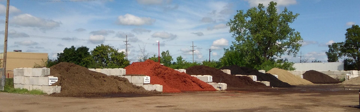 Bins of bulk mulch and topsoil at a landscape supply yard