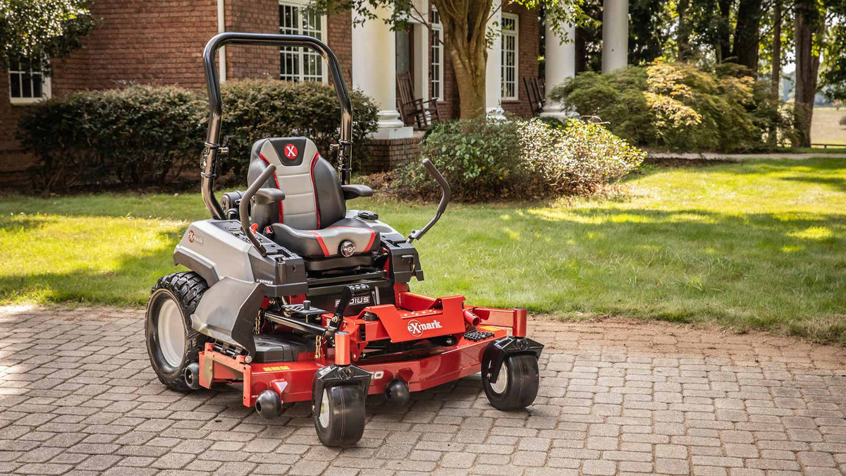 Exmark zero-turn mower on a striped front lawn