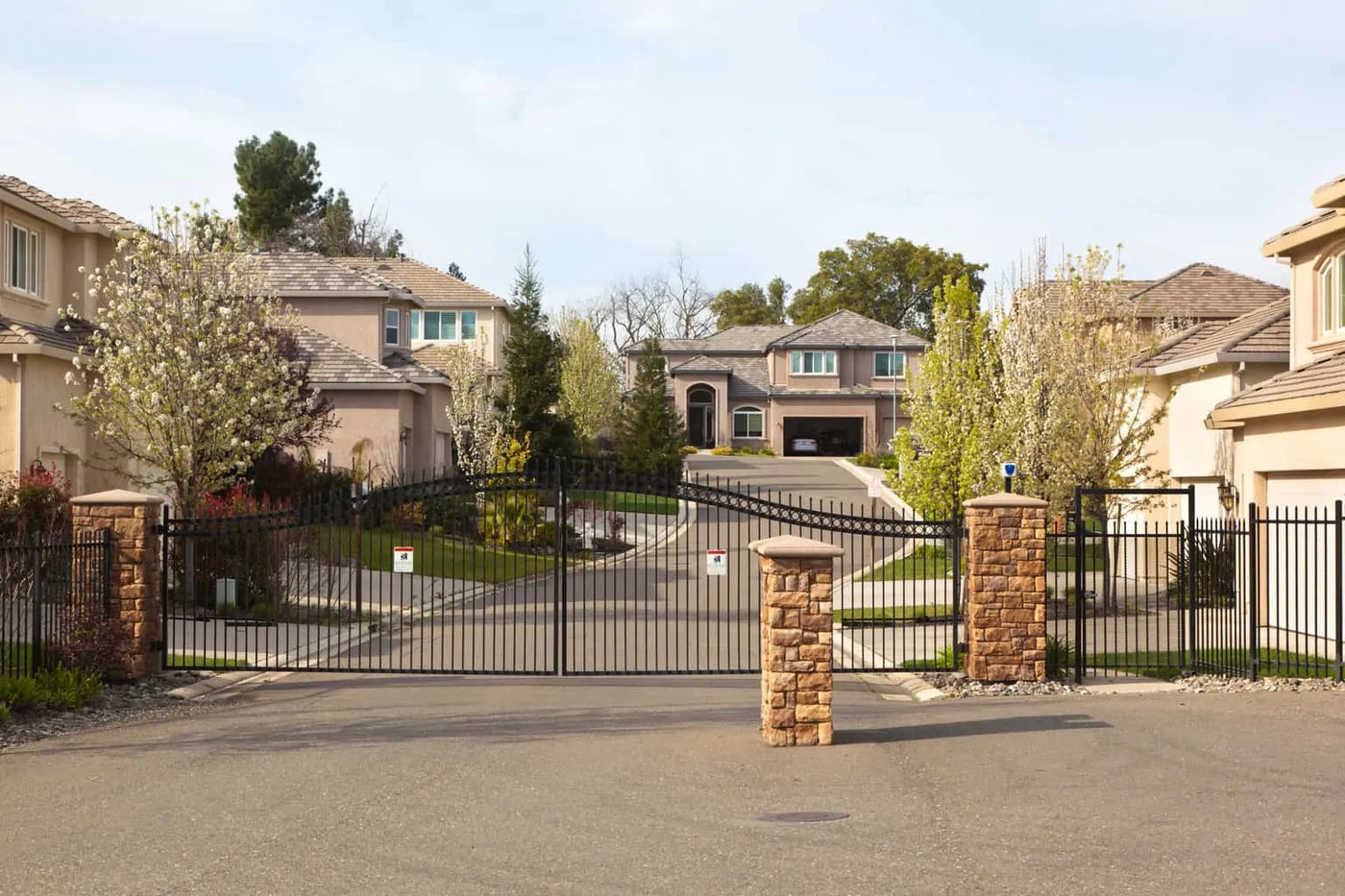 Gated residential community entrance with maintained trees and turf in Sheboygan County