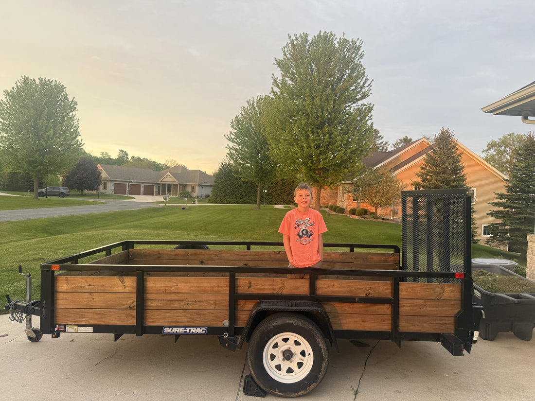 Mack standing in his first utility trailer the day it came home, still empty