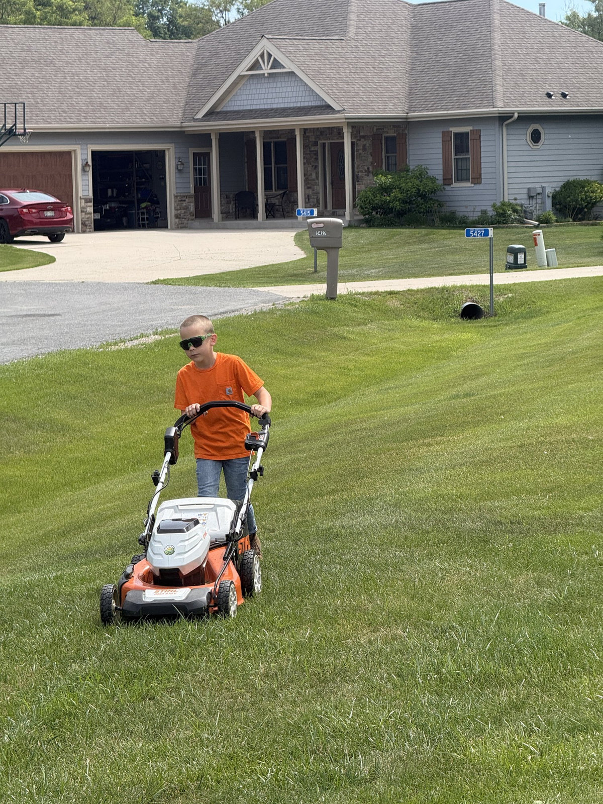 Mack mowing a large residential lawn