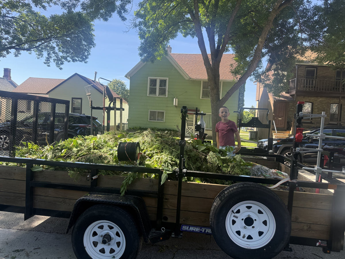 Trailer loaded with leaves and cleanup debris on a Sheboygan street
