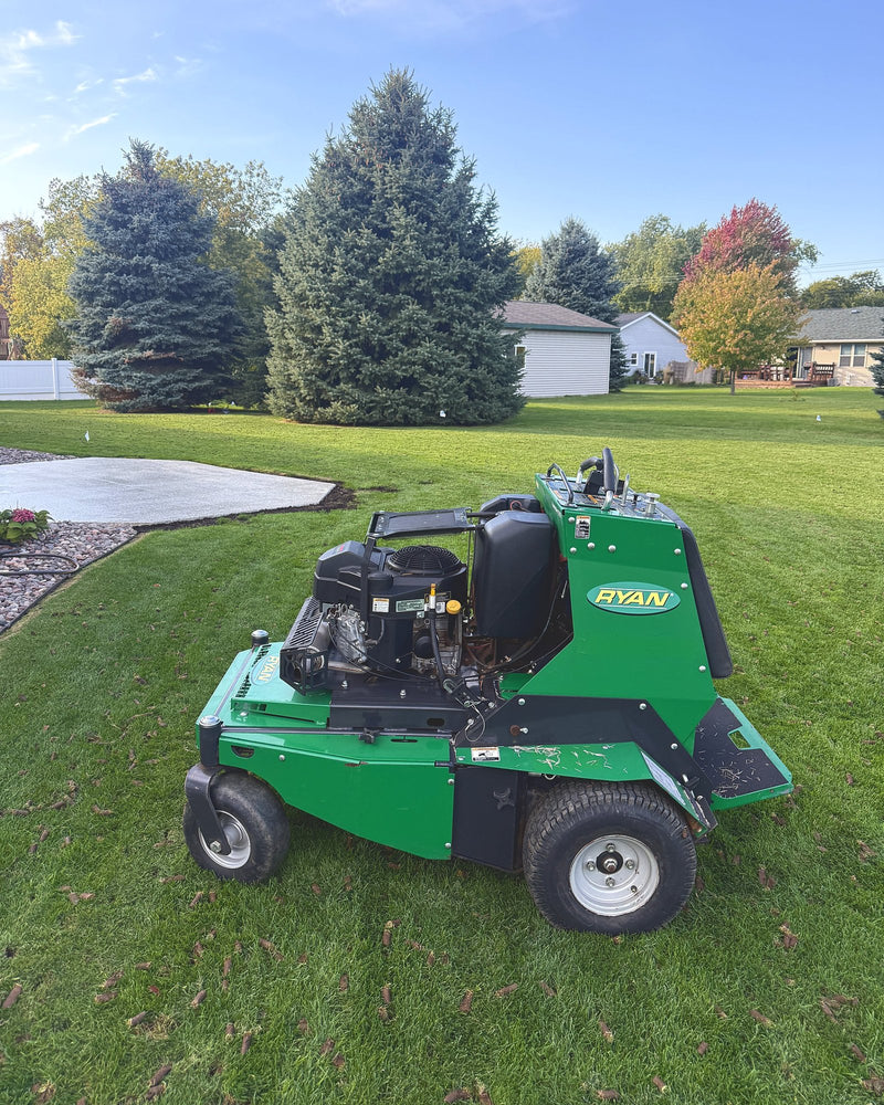 Sunny Stripes' Ryan stand-on core aerator on a freshly aerated lawn